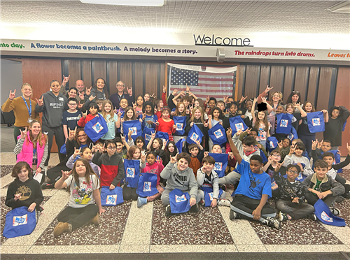 Holmes students hold up special bags from UB student athlete Kiara Johnson
